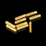 A collection of gold dart flight protectors laid out on a reflective surface.