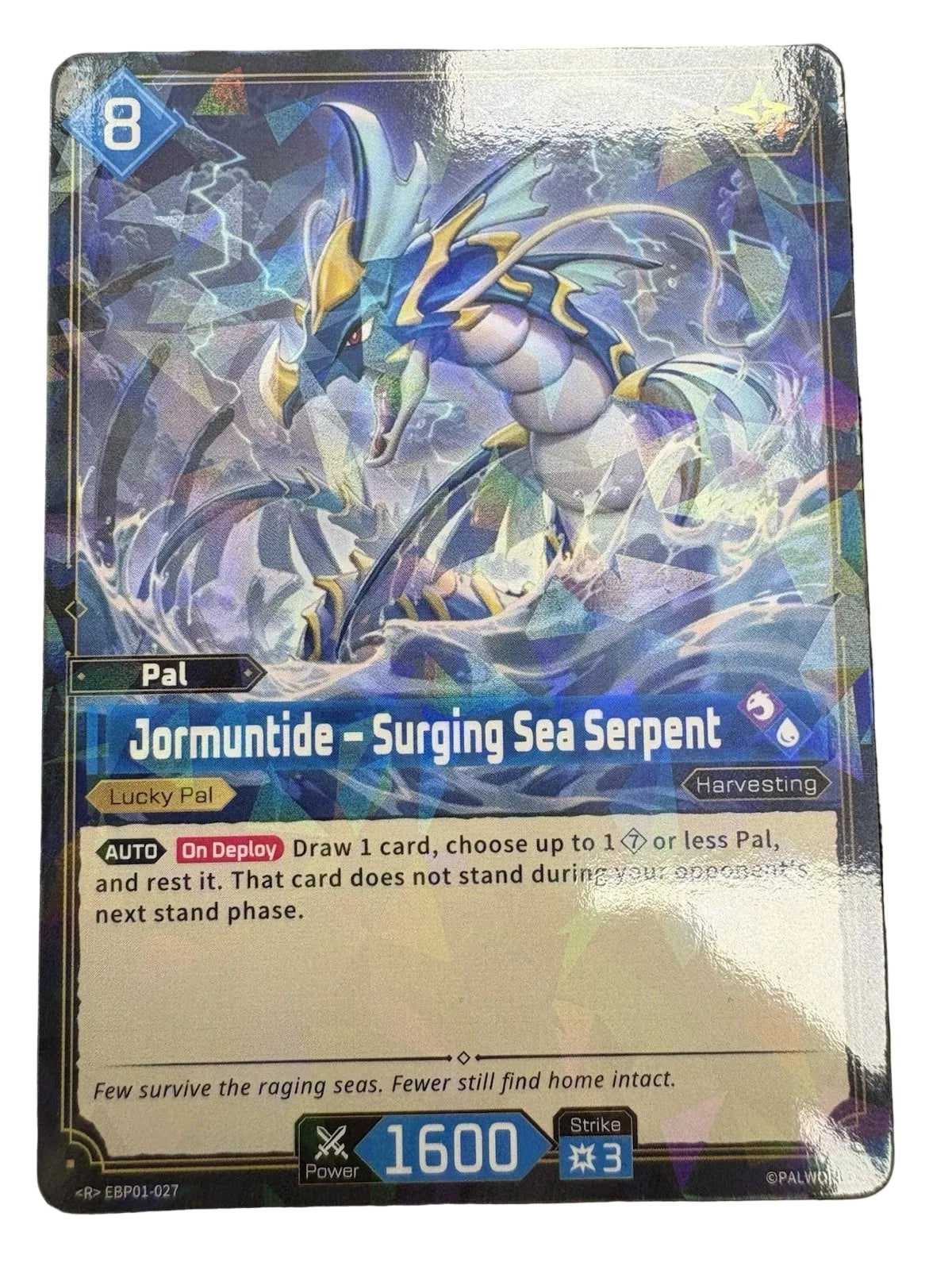 A holographic fantasy trading card featuring Jormungunde - Surging Sea Serpent, with blue, white, and purple artwork, photographed on a dark textured surface.
